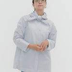 Model wearing white Sailor Ribbon Shirt with distinctive marine collar and decorative stitching details.