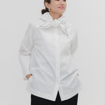 Model wearing white Sailor Ribbon Shirt with distinctive marine collar and decorative stitching details.